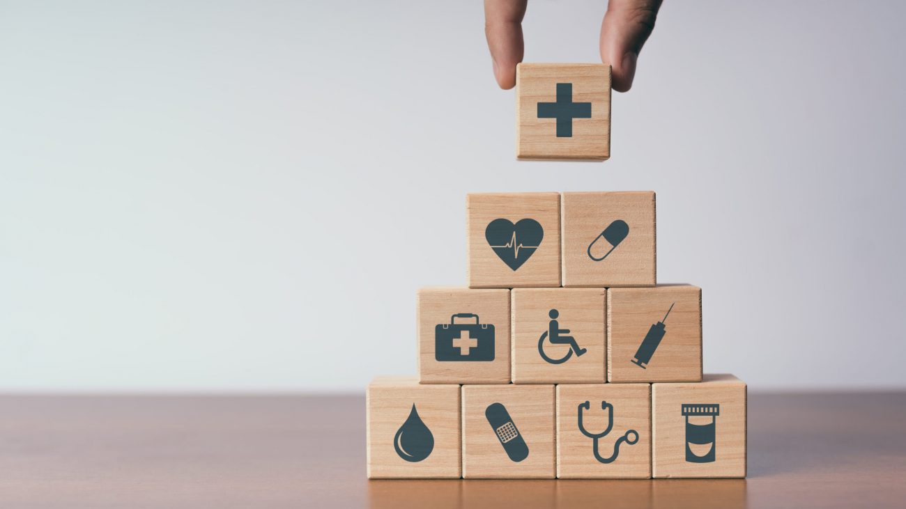 Concept of Insurance for your health, Hand hold wooden block with icon healthcare medical Zdravotne poistenie na slovensku