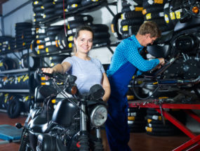 žena s motorkou v servise