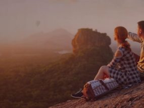 couple travelers watch a beautiful sunset near the famous rocky plateau Lion peak, Sigiriya. Sri Lanka