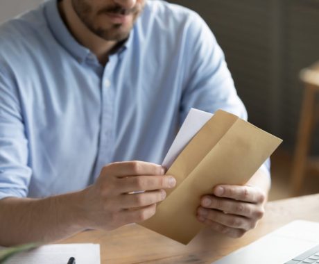 Close up of man open envelope with letter pozyvame na prehliadky